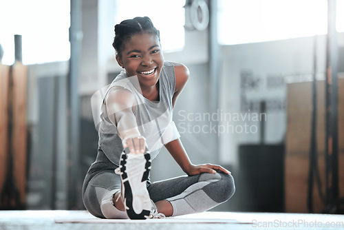 Image of Gym, happy or portrait of black woman stretching legs for workout or body movement for active fitness. Smile, athlete or healthy girl smiling in exercise training warm up for flexibility or mobility