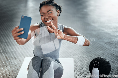 Image of Black woman, gym selfie and peace with smile on floor for fitness, workout and wellness on social media app. Influencer girl, photography and blog for exercise, icon and health for lifestyle in club