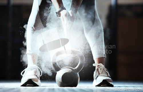 Image of Fitness, hands and powder at kettlebell in gym for workout, exercise and sports training. Closeup, athlete and legs of bodybuilder with heavy weight equipment, chalk dust and strong performance power