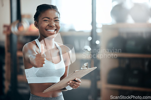 Image of Thumbs up, personal trainer portrait or happy black woman at gym for workout, exercise or fitness training. Healthy sports girl, thumb up or proud coach smiling with yes hand sign, like or clipboard