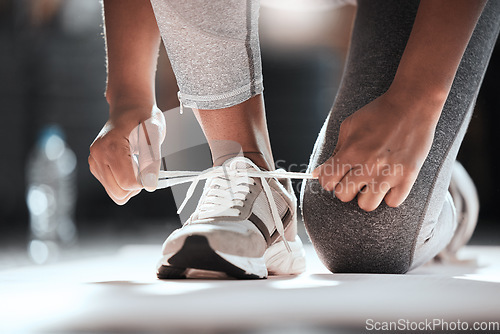 Image of Hands, shoelaces and floor at gym with woman, fitness and ready for workout, wellness or training. Girl, sport shoes or sneakers for exercise, performance or health for lifestyle, motivation and club