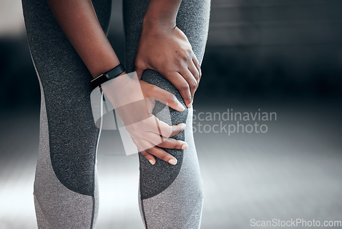 Image of Fitness, workout and closeup of woman with knee pain, injury or accident during training in a gym. Sports, medical emergency and zoom of female athlete with a sprain muscle in her leg at sport center