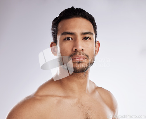 Image of Confidence, portrait and young man in a studio after a workout or body strength training. Serious, sports and face of attractive male model with muscles after exercise isolated by a white background.