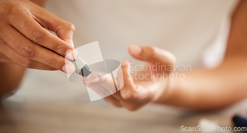 Image of Finger, diabetes and a person checking their blood sugar level in a home closeup for routine treatment. Hands, test and medical equipment with a diabetic adult taking a sample to check glucose