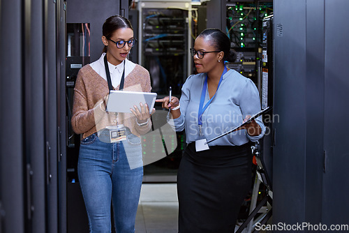 Image of Talking, server room and women with a tablet for cyber security, database planning and inspection. Teamwork, technician and female programmers speaking with technology for coding, hardware and system