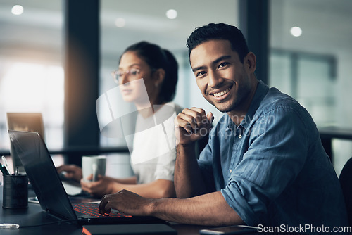 Image of Man, portrait and happy programmer on laptop in office for deadline at night. IT, face and male coder programming, coding or writing for software development or information technology with coworker.