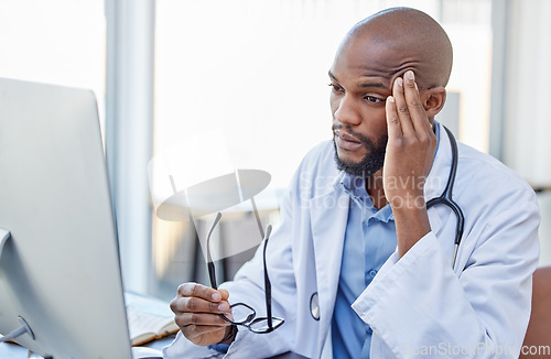 Image of Stress, black man and doctor with a headache, frustrated or burnout with a computer error, glitch or health issue. Male person, employee or medical professional with a migraine, technology or anxiety