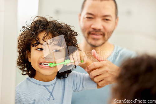 Image of Child, brushing teeth and father learning in a bathroom with dental health and cleaning. Morning routine, toothbrush and kid with dad together showing hygiene care at a mirror at home with grooming