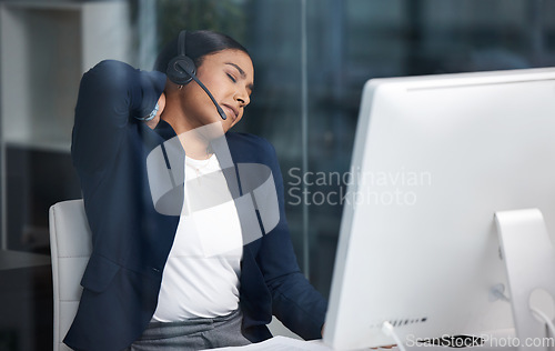 Image of Call center, customer service and woman with back pain in the office while working on an online consult. Medical emergency, sprain neck muscle and female telemarketing agent with crm communication.