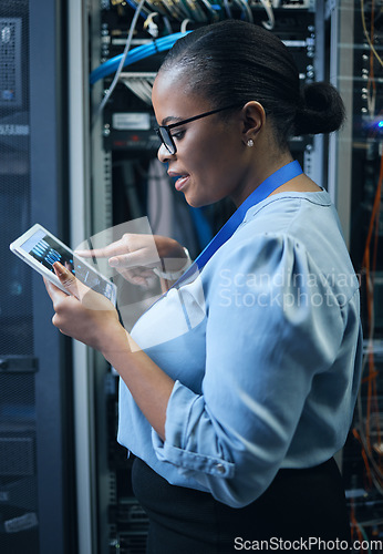 Image of IT woman, engineer and tablet in a server room for programming, cybersecurity or maintenance. Black female technician in datacenter for network, software or system upgrade app with technology