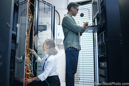 Image of Server room, engineer and IT team with a tablet for programming, cybersecurity or cable maintenance. Man and woman technician together in datacenter for network, software or system upgrade with tech