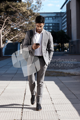 Image of Phone, city and Indian business man walking for travel, social media or internet search. Smartphone, texting and male person on walk in town while checking app, message or text on commute in street