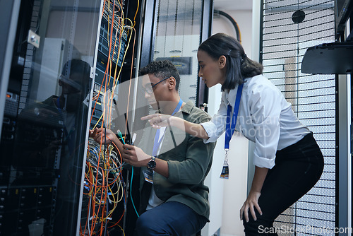 Image of IT people, engineer or server room cable for programming or connection maintenance. Man and woman technician in datacenter for network, cybersecurity software or data center problem or system upgrade