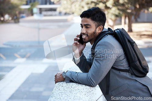 Image of Business man, backpack and phone call in street, city or smile with vision, networking or listen. Young indian businessman, outdoor and walk with smartphone, talk and professional in metro for travel