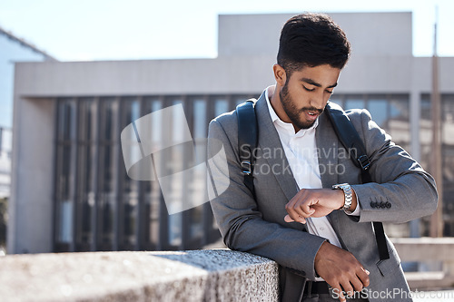 Image of Watch, time and corporate businessman in the city for cab, taxi or public transport to work. Travel, professional or young male employee waiting with a backpack in an urban town for commuting to work