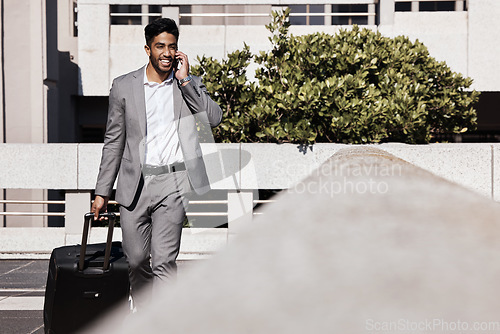 Image of Corporate phone call, travel and a businessman in the city for networking and conversation. Smile, contact and an employee talking on a mobile with luggage for a business trip or journey to airport