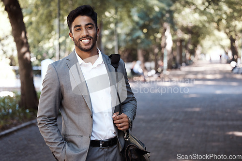 Image of Portrait, business and happy man in city for travel, morning commute or urban journey outdoor. Corporate male employee, entrepreneur and confident in street with pride, professional commitment or bag