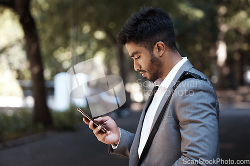 Image of Phone, search and Indian business man in a city for travel, social media and internet browsing. Smartphone, reading and male worker texting on app, message or tech on commute in a street in India