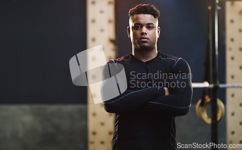 Image of Crossed arms, exercise and portrait of man in gym for training, fitness and bodybuilder workout. Motivation, muscles and serious male person in sports center for challenge, wellness and body strength