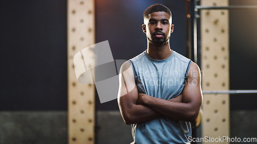 Image of Crossed arms, bodybuilder and portrait of man in gym for training, exercise and strong workout. Fitness, muscles and serious male person in sports center for challenge, wellness and body strength