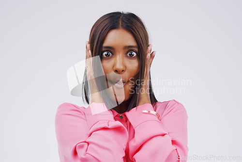 Image of Portrait, funny face and lips with an indian woman in studio on white background looking silly or goofy. Comedy, comic or crazy with a fun young female person sucking cheeks indoor for playful humor