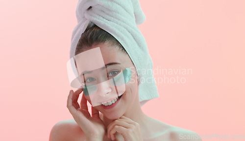 Image of Portrait, woman and skincare with eye mask in studio happy with beauty, collagen and anti aging on pink background. Face, patches and female model with skin cosmetics, facial and vitamin c treatment