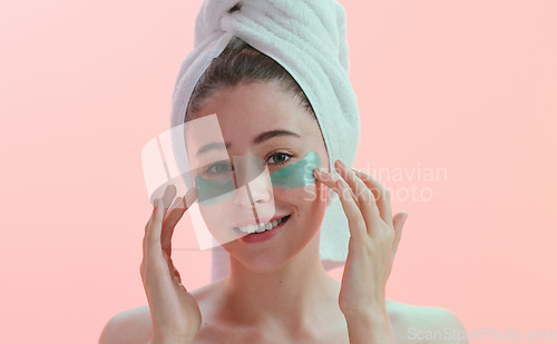 Image of Skincare, portrait and happy woman with eye mask in studio for beauty, collagen and anti aging on pink background. Face, patches and female model with skin cosmetics, facial and hydration treatment