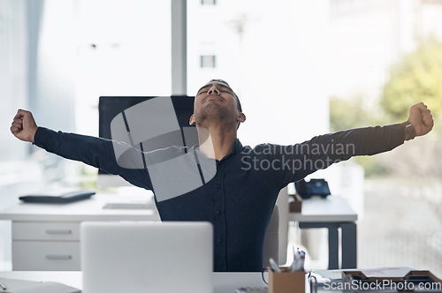 Image of Business man, celebration and laptop with winning, achievement and success on stock market. Young indian businessman, pc and winner with fist to celebrate profit, bonus and online gambling at desk