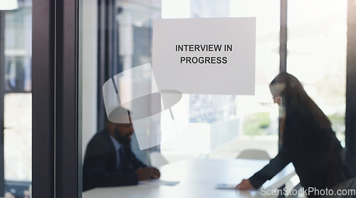 Image of Recruitment, window sign and business people in an interview in the modern office boardroom. Hiring, meeting and professional corporate employees doing recruiting process in workplace conference room