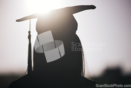 Image of Graduation, education and silhouette of a student woman outdoor on university campus with lens flare. Future, college and scholarship with a female graduate standing outside at an event from the back