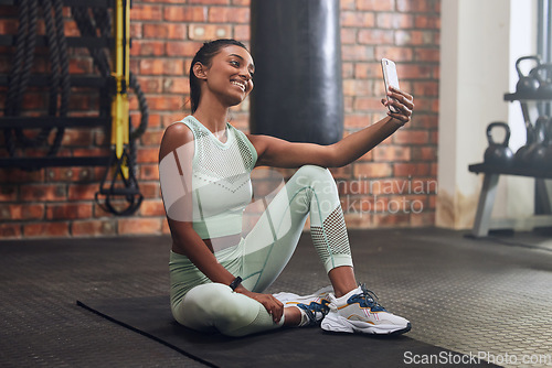 Image of Gym, fitness or happy woman taking selfie on workout, exercise or training break for social media. Wellness, smile or healthy Indian girl smiling, relaxing or taking pictures for online post