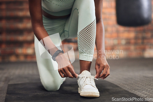 Image of Tie, start or hands of woman with shoes at gym for training, exercise or workout motivation in fitness center. Lace, closeup or legs of girl sports athlete with footwear ready to begin exercising