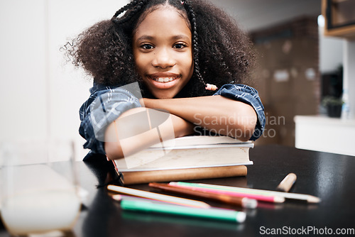 Image of Child, school books and happy for education, learning and development at a table in a house. Face portrait of an african girl kid or student with a smile, knowledge and happiness while studying