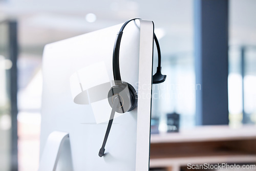 Image of Empty office, computer or call center headset for communication for telecom customer services. Help desk, background or crm workplace for technical support, telemarketing sales or consulting job