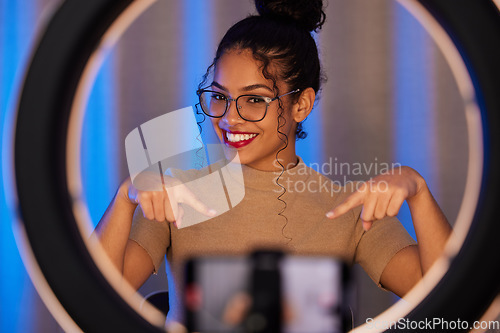Image of Influencer woman, ring light and portrait with smile, pointing and beauty on live stream, broadcast or web video. Girl, review or online entrepreneur with happiness, makeup or talking on social media