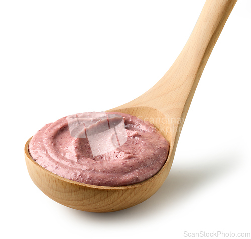 Image of red beans hummus in wooden ladle