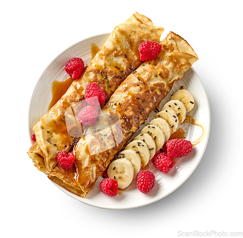 Image of freshly baked crepes with fresh fruits and caramel sauce
