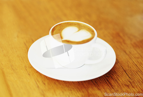 Image of Retro mug and latte on wooden table in a coffee shop at urban city with espresso with milk. Kitchen, cafe and cappuccino in restaurant to drink in mug and saucer at vintage kitchen in diner