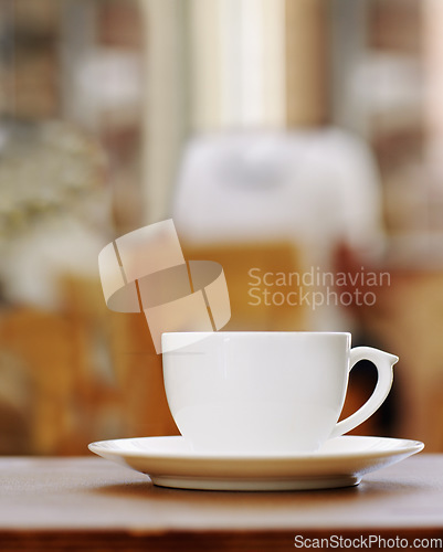 Image of Closeup of one coffee cup on table in a cafe, hot beverage and caffeine drink for breakfast or energy. Espresso, cappuccino and latte in hospitality industry with ceramic teacup and cacao liquid