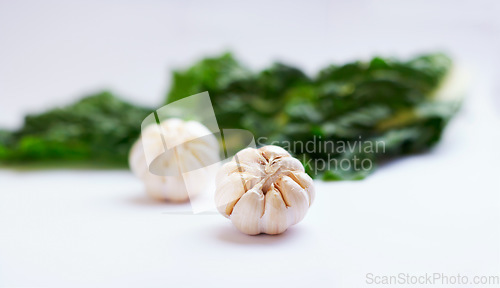 Image of Vegetable, garlic clove and healthy food in studio as art or creativity for nutritionist. Cooking, wellness diet and nutrition for clean, green or vegan meal ingredient isolated on a white background
