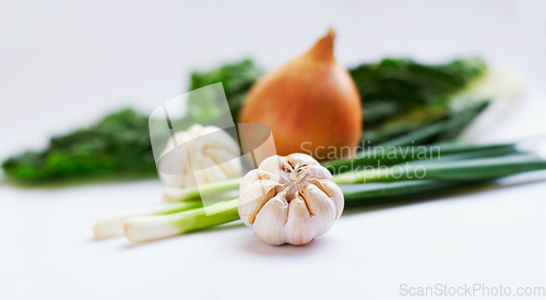 Image of Vegetable, ingredients and healthy food in studio with garlic, onions and scallions for creativity. Cooking, wellness diet and nutrition with clean, green or vegan meal isolated on a white background