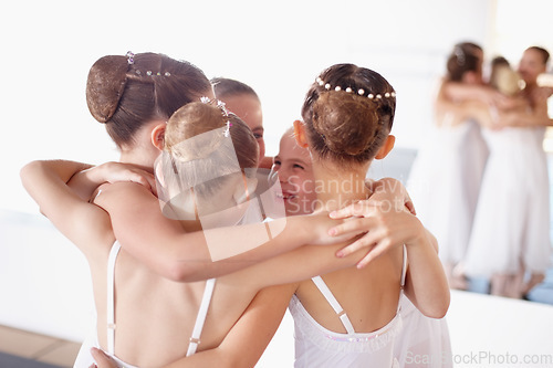 Image of Ballet, friends and hug or girl children smile and fun at dance studio or learn together. Happy, embrace and students in training or group celebrate at academy and young ballerinas or friendship