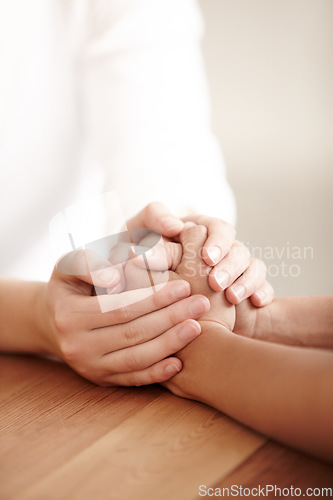 Image of Empathy, love and spiritual with people holding hands in comfort, care or to console each other. Trust, help or support with friends praying together during depression, anxiety or the pain of loss