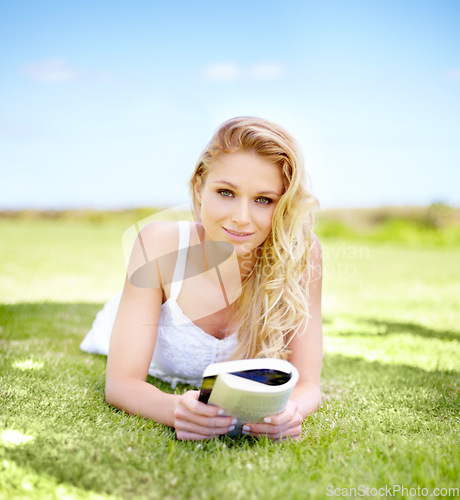 Image of Portrait, relax and woman with a book, grass and nature with a smile, knowledge and spring time. Face, female person and happy model with picnic, notebook and student in the park field during summer