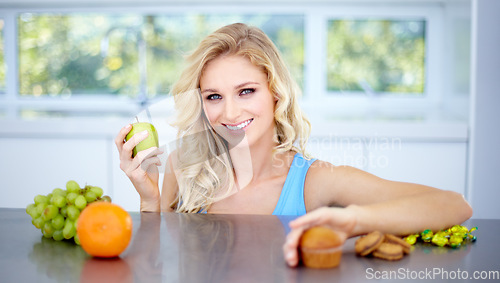 Image of Woman, portrait smile and fruit in healthy eating, nutrition or fiber in dieting on kitchen table. Happy female person smiling in happiness with apple for diet, organic meal or natural food at home