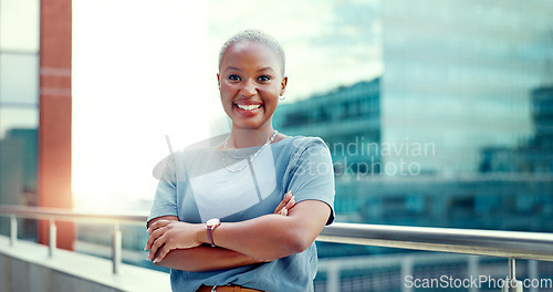 Image of Black woman in city for business portrait while happy and arms crossed outdoor with vision and pride. Face of entrepreneur person with urban buildings and motivation for career goals as future leader