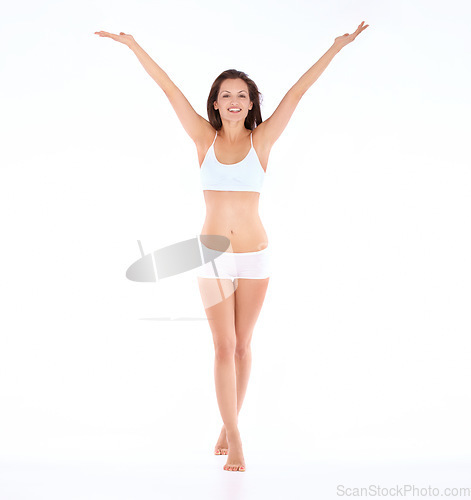 Image of Portrait, smile and woman in underwear in studio for body care, self love and positivity against a white background. Happy, free and female model excited for beauty results, weight loss and diet