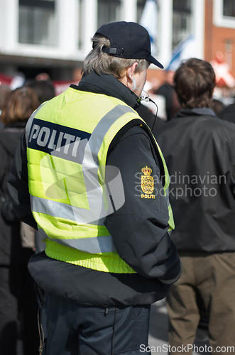 Image of Safety, protection and security with police officer in city for peace, law enforcement and authority. Emergency services, justice and guard with person in street for help, order and arrest