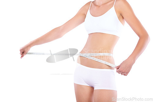 Image of Hands, measuring tape and woman in studio for weight loss, fitness for wellness, health and white background. Isolated model, girl and underwear with diet, waist and stomach with healthy lifestyle
