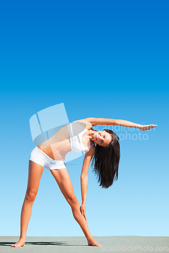 Image of Woman, yoga and stretching arms for body, workout or exercise standing on floor against blue sky. Calm and peaceful female yogi in warm up arm or fitness stretch for healthy living on mockup space